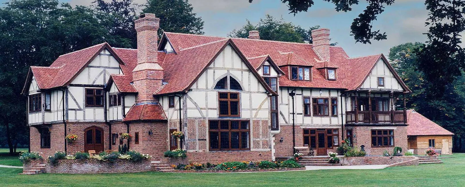 Large Tudor-style house with a handmade clay tile roof